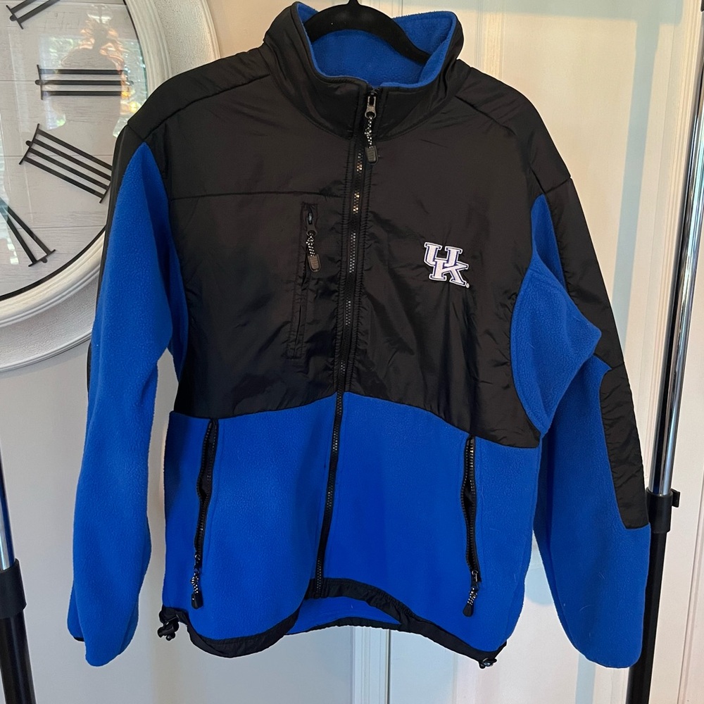 UK Fleece/Nylon full Zipper w/ 2” collar. Kentucky Wildcats stitched on back